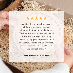 May include: A five-star review for a personalized wooden plaque with the text "You're the best Daddy, hands down!" and "Love from Lewin & Reuben". The review mentions the seller's helpfulness, the quality of the product, and fast delivery. The review is dated 2022 and includes the social media handle @millerandolive_official.