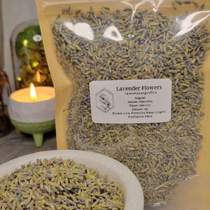 May include: A clear plastic bag filled with dried lavender flowers. The bag has a white label with the text "Lavender Flowers, Lavendula angutifolia, Magical, Gender: Masculine, Planet: Mercury, Element: Air, Powers: Love, Protection, Sleep, Longevity, Purification, Peace."