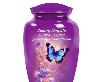 May include: Purple cremation urn with a butterfly and floral design. The urn has the text "Loving Angelea 2-3-1950 - 2-2-2022 Forever Loved and Missed".