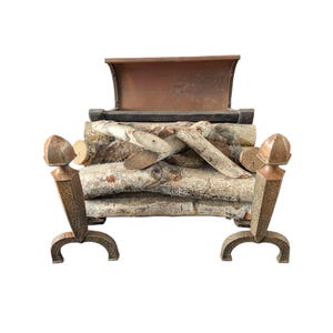 May include: A decorative fireplace log holder with a rustic design. The holder features a dark metal frame with decorative accents and holds a stack of birch logs. The top of the holder has a copper-coloured finish.