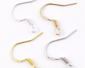 May include: Four earring hooks, two silver and two gold, with spring closures. The hooks are designed for hanging earrings.