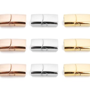 May include: Nine magnetic clasps for jewelry making. Three clasps are gold, three are silver, and three are rose gold.