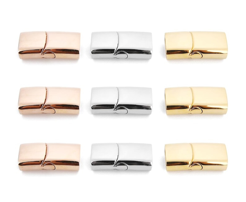 May include: Nine magnetic clasps for jewelry making. Three clasps are gold, three are silver, and three are rose gold.