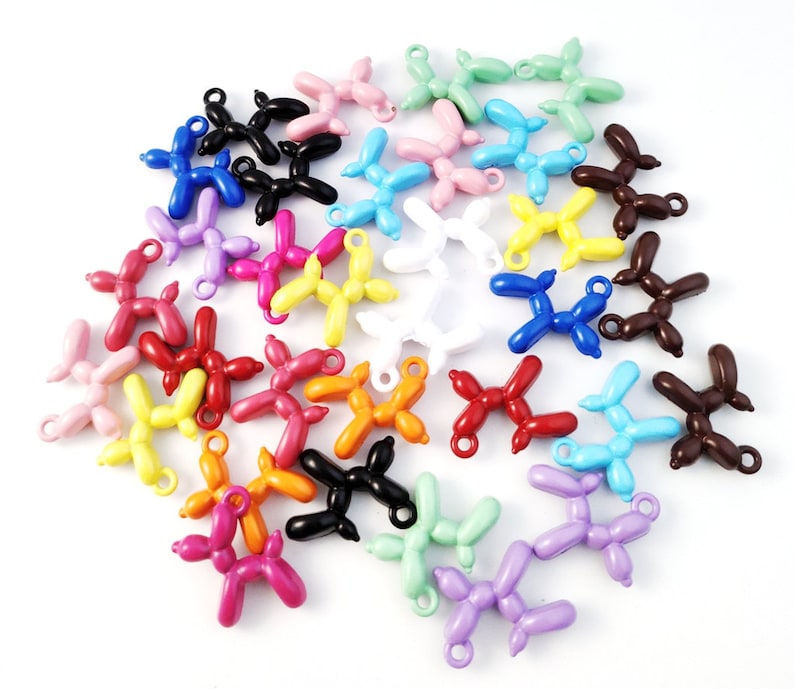 May include: A collection of colorful balloon dog charms in various colors, including red, orange, yellow, green, blue, purple, pink, brown, black, and white. The charms are made of metal and have a loop at the top for attaching to a necklace, bracelet, or keychain.