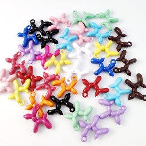 May include: A collection of colorful balloon dog charms in various colors, including red, blue, green, yellow, orange, pink, purple, brown, black, and white. The charms are made of metal and have a shiny finish.