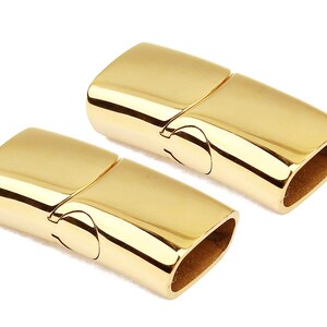 May include: Two gold-toned magnetic clasps for jewelry making. The clasps are made of metal and have a polished finish.