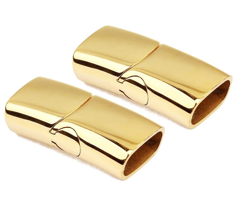May include: Two gold-toned magnetic clasps for jewelry making. The clasps are made of metal and have a polished finish.