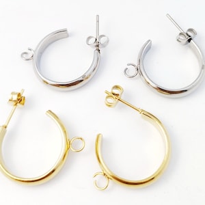 May include: Two pairs of hoop earring blanks, one pair is gold and the other is silver. Each pair has a jump ring for attaching charms or pendants.