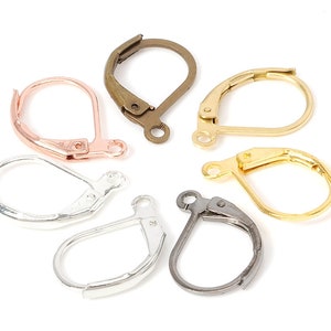 May include: Assortment of six earring hooks in different metal finishes: silver, gold, rose gold, and gunmetal. The hooks are all the same size and shape, with a simple, classic design.