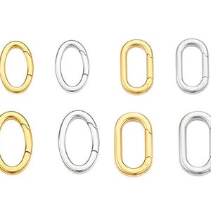 Può includere: Otto chiusure ovali in oro e argento su sfondo bianco. Quattro sono dorate, quattro argentate. Ogni chiusura ha un meccanismo di apertura a cerniera. Ideale per la creazione di gioielli o l'artigianato.