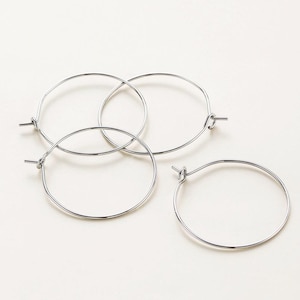 May include: Three silver hoop earrings, each with a simple circular design.