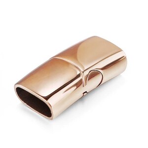 May include: Rose gold magnetic clasp for jewelry making. The clasp is rectangular and has a smooth, polished finish.