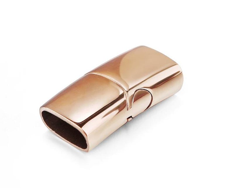 May include: Rose gold magnetic clasp for jewelry making. The clasp is rectangular and has a smooth, polished finish.