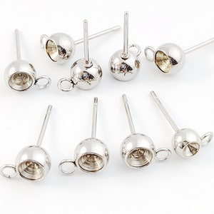 May include: Ten silver earring posts with a small loop on the side. The posts are round and have a smooth finish.
