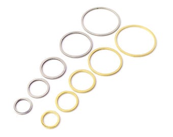 May include: A set of nine jump rings in two different sizes and colors. The jump rings are silver and gold, and they are arranged in a descending size order from left to right.
