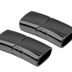 May include: Two black magnetic clasps for jewelry making. The clasps are made of metal and have a smooth, polished finish.