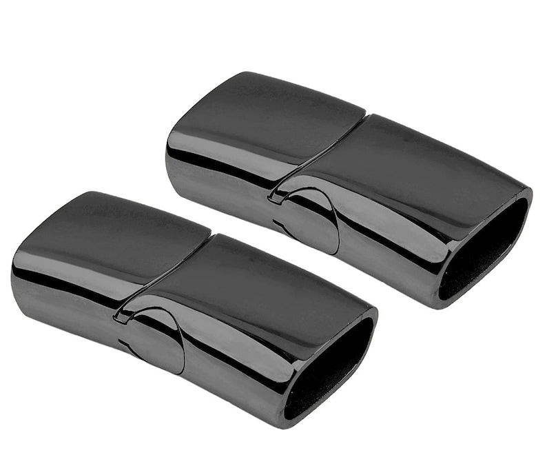May include: Two black magnetic clasps for jewelry making. The clasps are made of metal and have a smooth, polished finish.