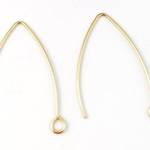 May include: Two gold-colored earring hooks with a small loop at the end.