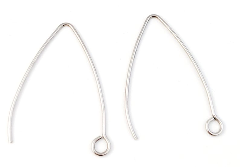 May include: Two silver earring hooks with a small loop at the end. The hooks are made of metal and are designed to be used with earrings.