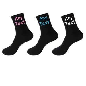 May include: Three pairs of black socks with the text "Any Text" embroidered on them in pink, blue and white.