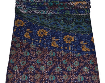 May include: A blue and green kantha quilt with a floral pattern. The quilt is folded and stacked, showing the layers of fabric.