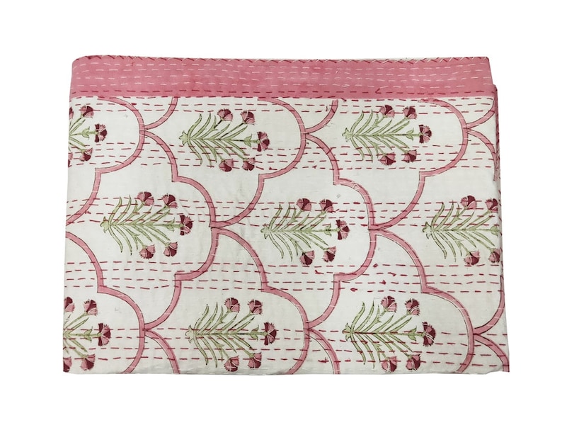 May include: A white cotton quilt with a pink floral pattern. The quilt is hand-stitched with a running stitch and has a pink border.
