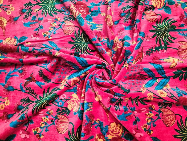 May include: Pink fabric with a floral print featuring blue birds, green leaves, and yellow flowers.