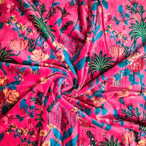 May include: Pink fabric with a floral and bird print. The fabric features a repeating pattern of flowers, birds, and leaves in shades of pink, blue, green, and yellow.