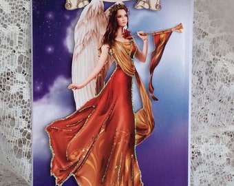 May include: A Christmas card featuring an angel with golden wings and a red dress playing a trumpet. The card has a purple background with stars and the text "Merry Christmas" on a banner.