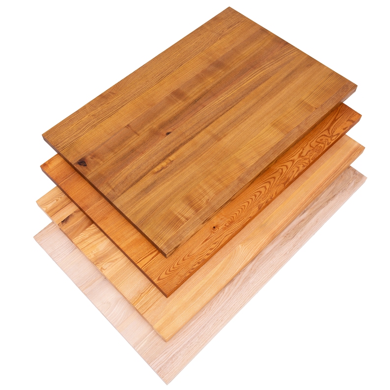 May include: A stack of five rectangular wooden planks in varying shades of brown and tan. The planks are arranged diagonally, showcasing the natural wood grain and color variations, from light beige to a rich, dark brown.