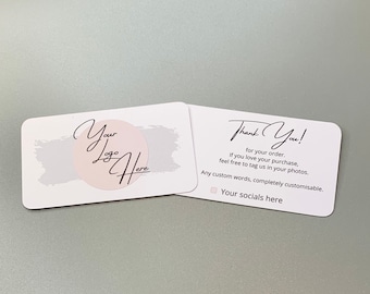May include: Two white business cards with rounded corners. The left card has a pink circle with the text "Your Logo Here" in black cursive writing. The right card has the text "Thank You!" in black cursive writing. The text below reads "for your order. If you love your purchase, feel free to tag us in your photos. Any custom words, completely customisable. • Your socials here."