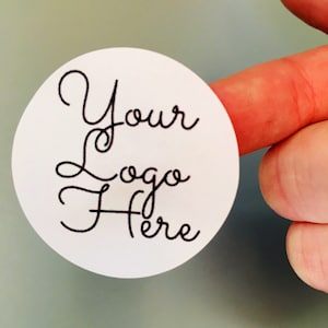 May include: White round sticker with black cursive text that says "Your Logo Here".