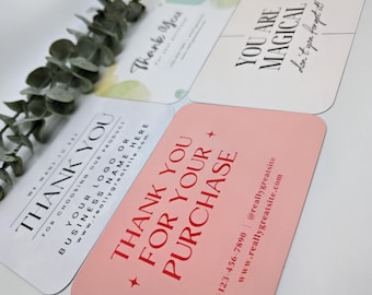 May include: A collection of four rounded-corner cards with text. One card is pink with red text that says "THANK YOU FOR YOUR PURCHASE." Another card is white with black text that says "THANK YOU." The other two cards have text that says "YOU ARE MAGICAL" and "Thank You."