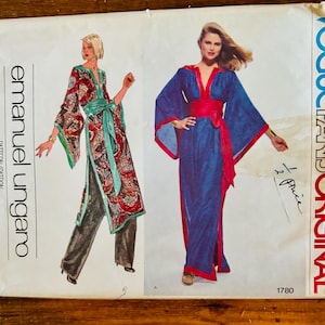 Könnte beinhalten: Vintage Vogue Paris Original Schnittmuster Nr. 1780 von Emanuel Ungaro. Das Schnittmuster zeigt zwei Designs für eine lange, fließende Robe mit V-Ausschnitt und weiten Ärmeln. Ein Design ist in einem blau-roten Farbschema gehalten, das andere in einem grün-rot-schwarzen Farbschema.