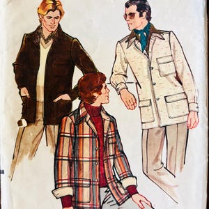 May include: Vintage Vogue Patterns for Men sewing pattern, number 8972, size 42. The pattern features three men wearing different jackets. One man is wearing a brown corduroy jacket, another is wearing a plaid jacket, and the third is wearing a white jacket with a patterned design.