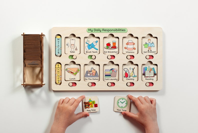 May include: A wooden board with a daily routine chart for kids. The chart has slots for cards with pictures of activities like brushing teeth, eating breakfast, and reading. The board also has a slot for a card that says "My Daily Responsibilities".