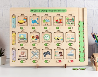 May include: A wooden chart with a green border and the title "Wyatt's Daily Responsibilities". The chart is divided into three sections: morning, afternoon, and evening. Each section has a series of activities with illustrations and a toggle switch. The activities include making the bed, brushing teeth, getting dressed, eating breakfast, yard work, screen time, art time, your time, washing the car, visiting grandparents, roller skating, cutting nails, playing time, eating dinner, and showering. There are green stars on the right side of the chart.
