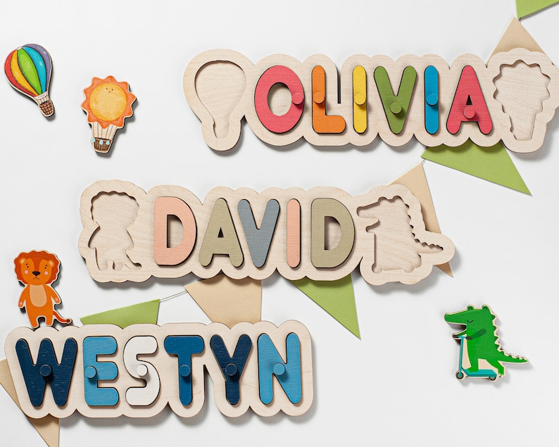 May include: Three wooden name puzzles with colourful letters. The names are Olivia, David, and Westyn. Each puzzle has a small animal or object on the end.