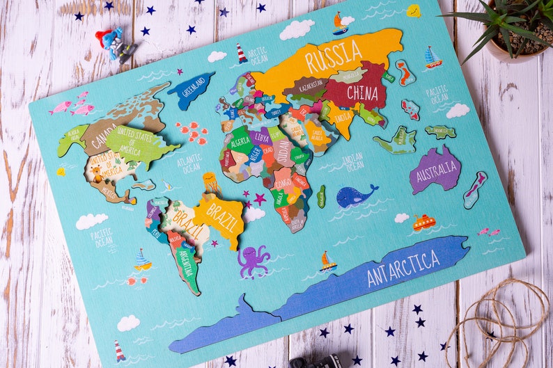 Wooden world map Montessori puzzle for kids features a colorful world map with the names of the countries, continents, and oceans.