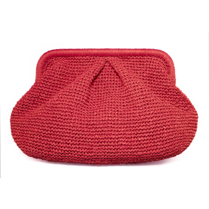 Puede incluir: Un bolso de mano de crochet rojo con la parte superior fruncida y una textura lisa y tejida.