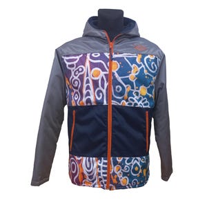 May include: A grey hooded jacket with a colourful abstract pattern on the front. The jacket has a navy blue panel and an orange zip. The sleeves are grey.