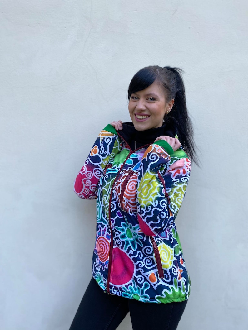 May include: A colourful jacket with a zip fastening and a swirling, abstract pattern in shades of blue, green, yellow, red, and pink.