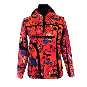 May include: A red, black and blue patterned hooded jacket with a zip closure. The jacket has a unique abstract design with a variety of shapes and colours.