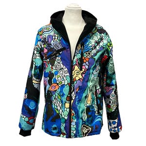 May include: A colourful hooded jacket with a black zip and a psychedelic pattern. The jacket has a black hood and black cuffs.