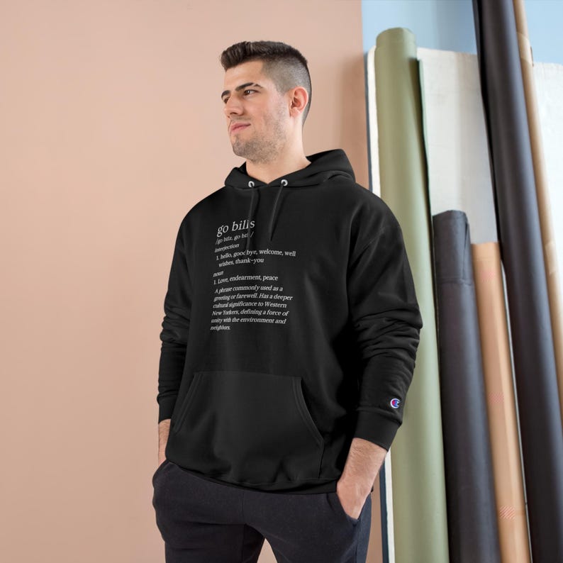 May include: Black hooded sweatshirt with a white graphic print of the word "go bills" defined as "a love, endearment, peace greeting commonly used as a phrase of farewell. Has a deeper cultural significance to Western New Yorkers, defining a force of unity with the environment and neighbors."