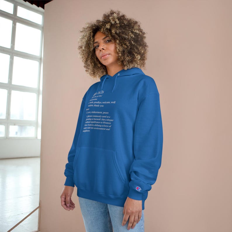 May include: A royal blue hooded sweatshirt with a white print that defines the word "grace" as "a gift, a blessing, welcome, well wishes, thank you, love, understanding, peace, I plan or convey a good as a gift or favor, has a deeper meaning, forgiveness, liberation, new feathers, dancing in a story of our future, defining a love of nature, accepting a gift of the environment and supplies."