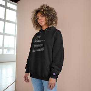 May include: Black hooded sweatshirt with a white graphic print that defines the word "good vibes" as "a state of positive, welcome, well wishes, thank you".