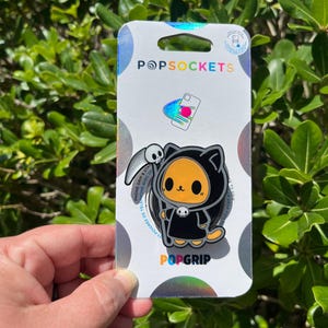 May include: A white ceramic mug with a black handle and the text "But First, Coffee" in a black, bold font. The mug is on a white surface. The mug is approximately 4 inches tall.