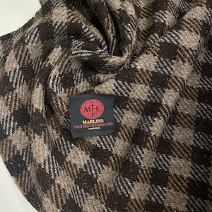 May include: Brown and beige patterned fabric with a woven label that reads "Marling Evans, Finest West of England cloth, 1788, Made in the UK."