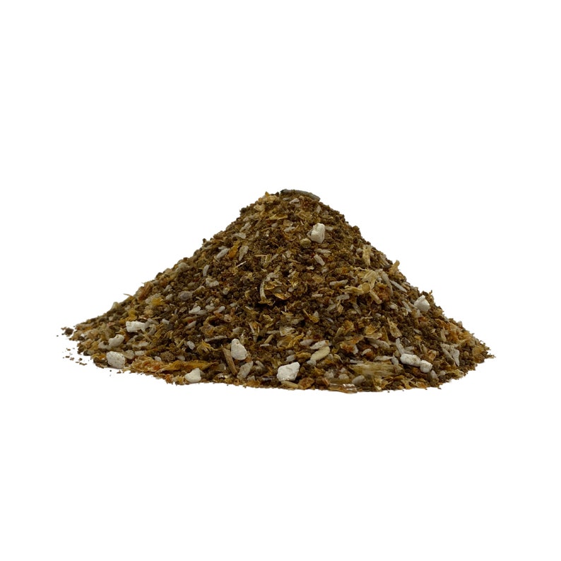 May include: A pile of brown and white compost, a mixture of shredded leaves, wood chips, and other organic matter.
